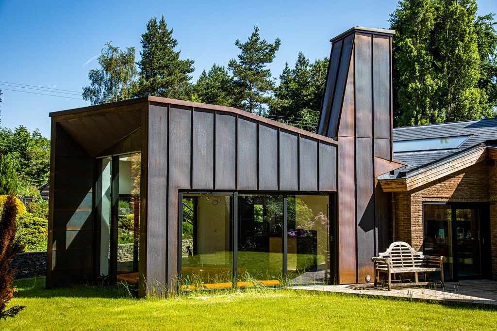 outside view of a contemporary house surrounded by green grass