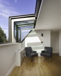 Bespoke rooflight in modern property with two chairs in the image and natural daylight.