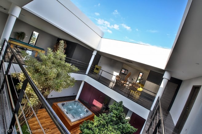 large sliding rooflight installed in hotel with a view of the blue sky through