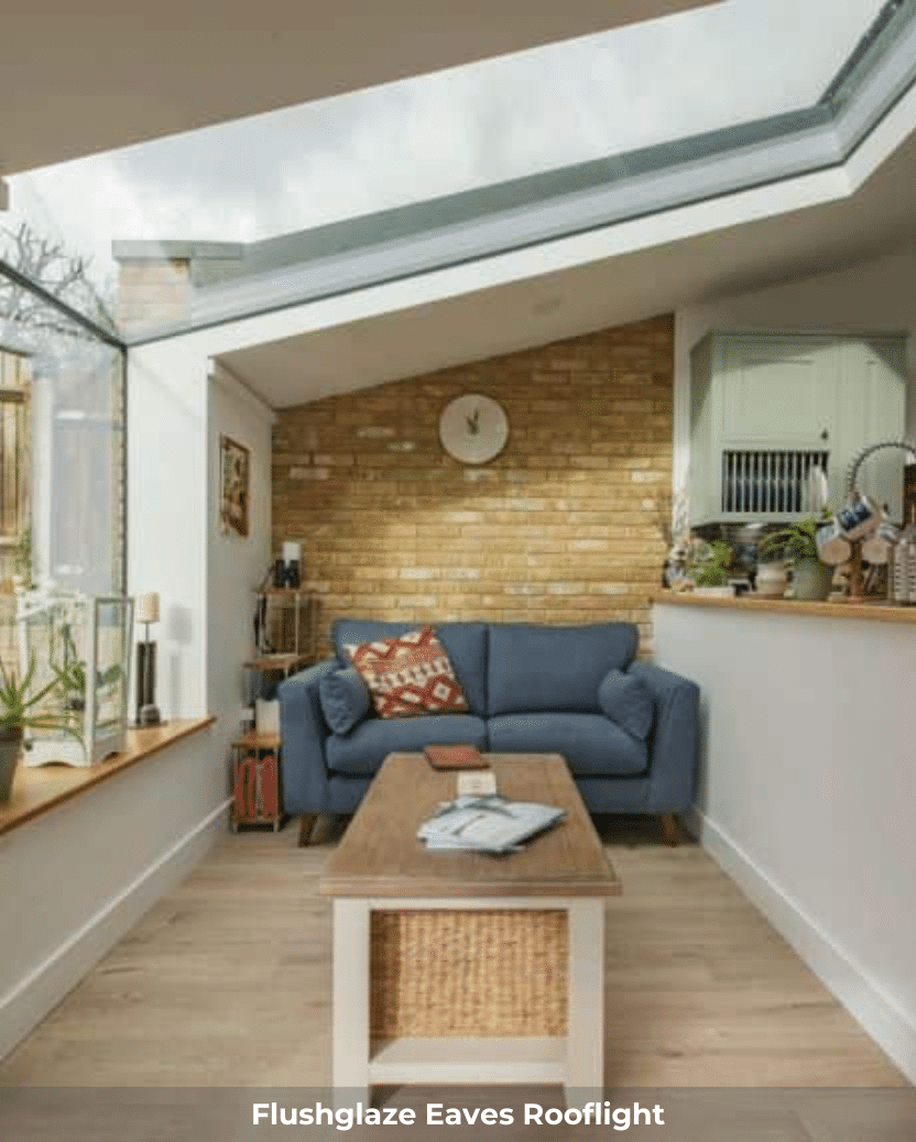 up and over rooflight installed over a blue sofa and living room