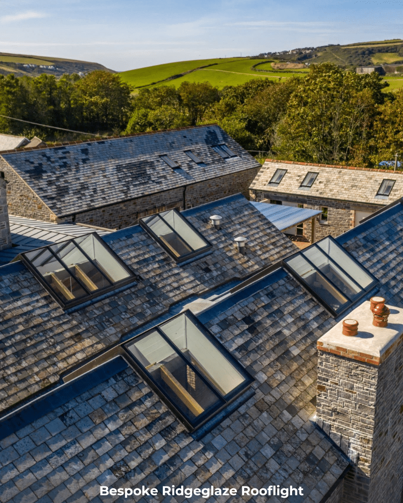 rooflights installed on a roof in the countryside by green land and trees