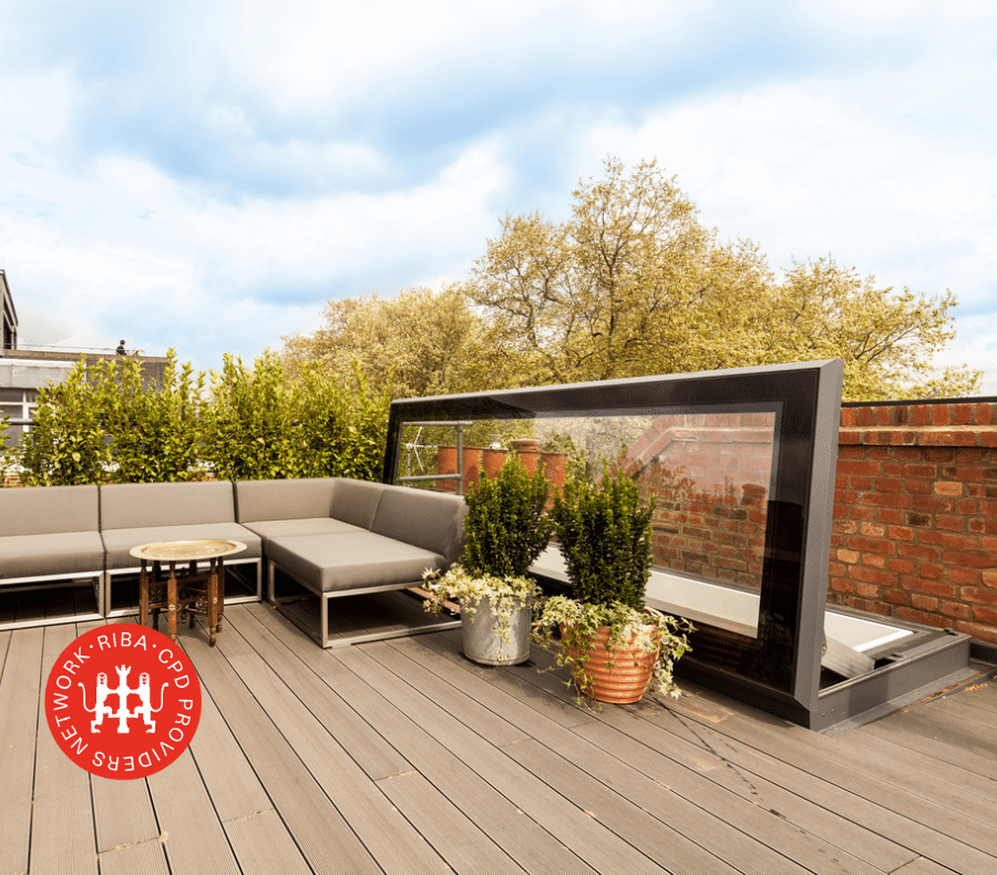 Glazing Vision Skydoor on a roof terrace with an outside sofa and potted plants, RIBA Approved CPD logo in bottom left corner